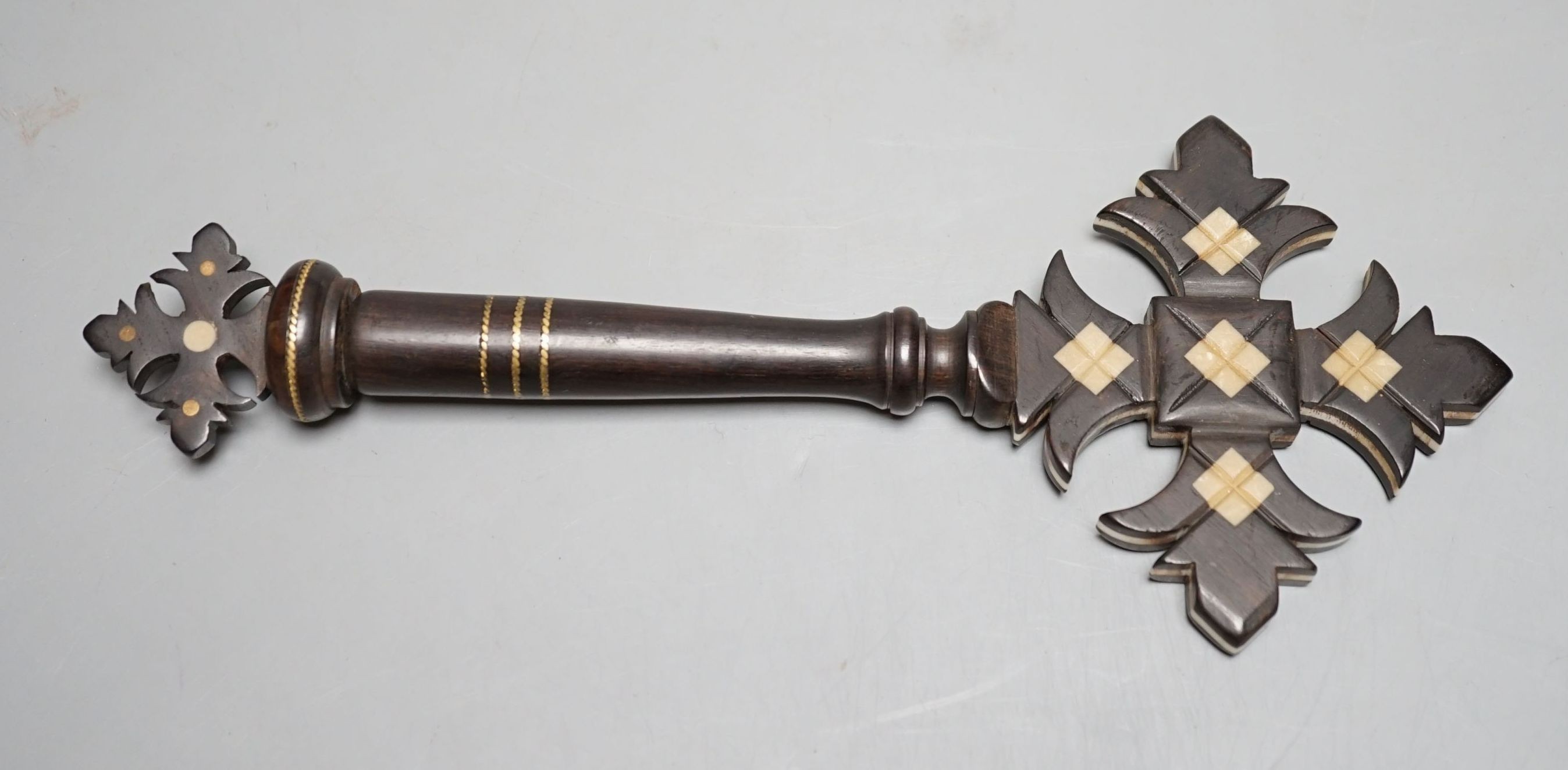 An ebony and ivory cross with holy water compartment, 25 cms long.